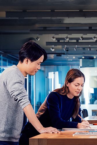 Apple designers collaborating on a project in their studio.