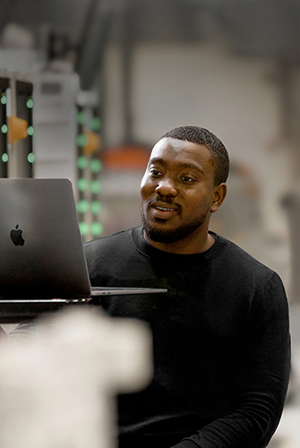 An Apple Operations and Supply Chain team member working on his MacBook.
