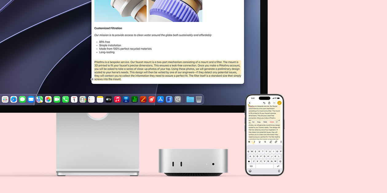 Mac monitor, silver Mac mini, and iPhone placed in a row, with the monitor display and the iPhone screen demonstrating the Universal Clipboard feature of copying and pasting from one Apple device to another