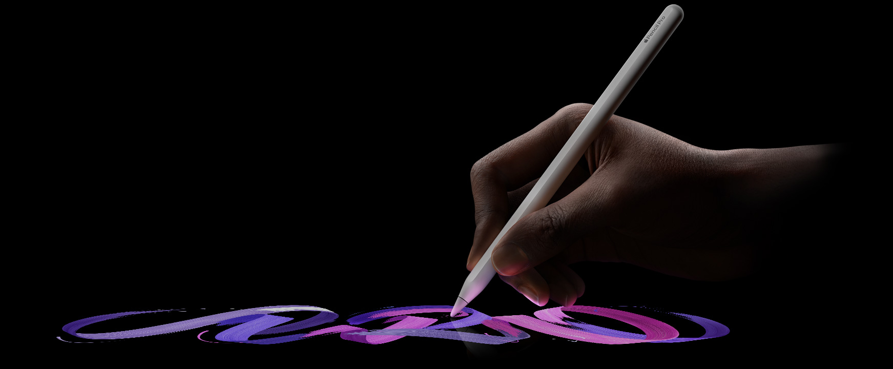 Dłoń malująca za pomocą Apple Pencil Pro linię w jaskrawym kolorze jednym pociągnięciem pędzla