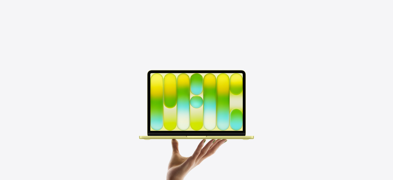 MacBook Neo in bright citrus color, balanced on fingertips of open hand, screen displaying colorful abstract pattern