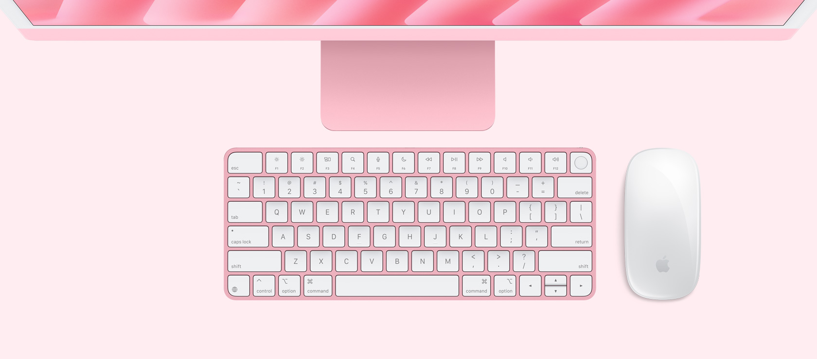 Imagem aérea de um iMac rosa com mouse e keyboard na mesma cor