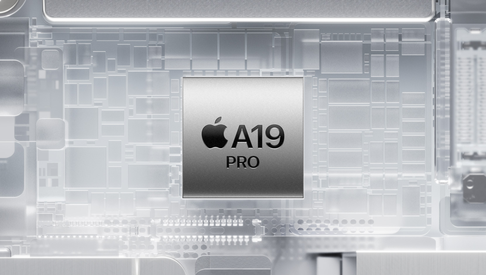 희미하게 빛나고 있는 iPhone 내부 부품들 사이에 장착되어 있는 A19 Pro 칩